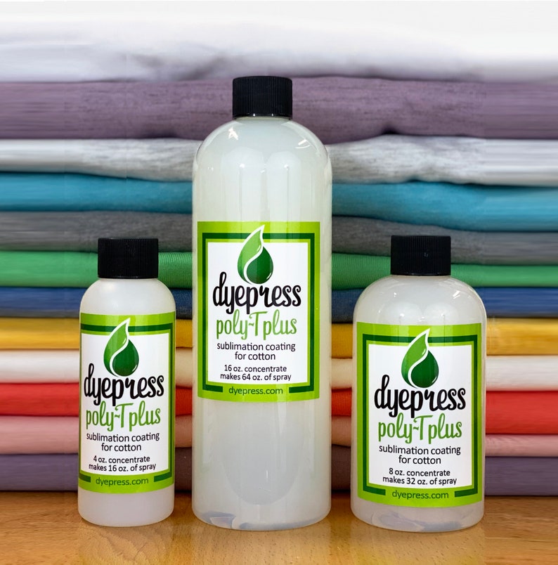 May include: Three bottles of dye press poly-Tplus sublimation coating for cotton. The bottles are clear and labeled with the product name, size, and instructions. The bottles are arranged in a row from smallest to largest. The bottles are sitting on a stack of colorful fabric.