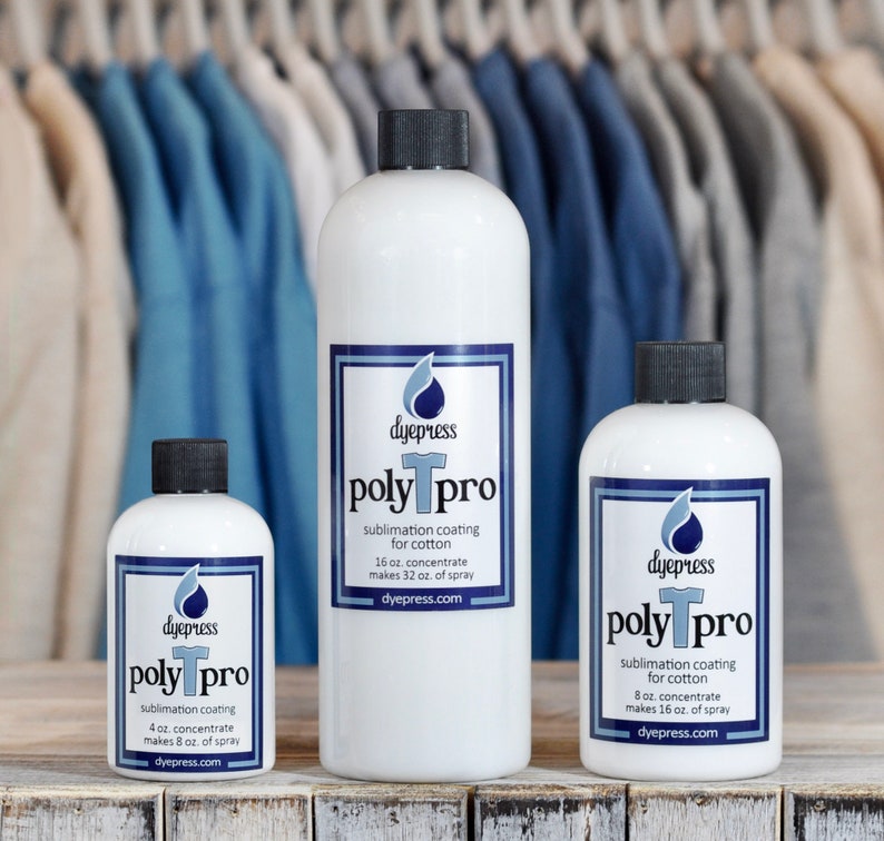 May include: Three bottles of dye press poly pro sublimation coating for cotton. The bottles are white with black caps and blue and white labels. The bottles are labeled with the size of the concentrate and the amount of spray it makes. The bottles are sitting on a wooden surface.