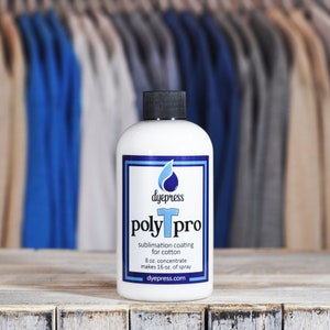 May include: A white bottle of dye press poly pro sublimation coating for cotton. The bottle is labeled with the product name, instructions, and the company website. The bottle is sitting on a wooden surface.