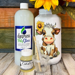 May include: A set of sublimation coating supplies for hard substrates, including a 450 ml bottle of clear Poly Gloss, a small bottle of catalyst, two syringes, and wooden skewers. The bottle of Poly Gloss has a blue label with the text "dyepress Poly Gloss" and a description of the product. The catalyst bottle has a yellow label with the text "Catalyst" and a description of the product.