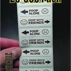 May include: A strip of white stickers with the text "POOP ALONE" and "POOP WITH FRIENDS", each accompanied by a sad or happy face. The text "25-500 Pack" is at the top. The brand name "SlickSticksLLC" is on the side.