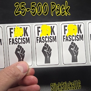 May include: A sheet of stickers with the text "F**k Fascism" and a black fist graphic. The stickers are rectangular with a white background and black text. The text "25-500 Pack" is written in yellow. The brand name "SlickSticksLLC" is also visible.