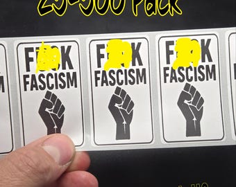 May include: A sheet of stickers with the text "F**k Fascism" and a black fist graphic. The stickers are rectangular with a white background and black text. The text "25-500 Pack" is written in yellow. The brand name "SlickSticksLLC" is also visible.