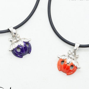 May include: Two necklaces with black cords and silver charms. One charm is a purple pumpkin and the other is an orange pumpkin. The charms are enamel painted and have a 3D design. The text "HALLOWEEN 2021" is visible in the top right corner of the image.