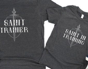YOUTH Saint in Training T Shirt with Cross Sword and Armor - Catholic Apparel for Boys and Girls - Unisex Short Sleeve Tee