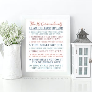 May include: A printable wall art design featuring the Ten Commandments in a white frame with a light blue and pink color scheme. The text is in a decorative font and includes the phrase "Thou Shalt Not..." for each commandment.