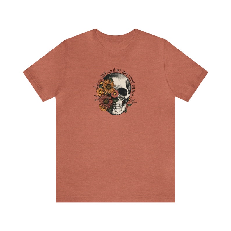May include: A heather red t-shirt with a skull graphic. The skull is surrounded by flowers and the text "and to dust you shall return".