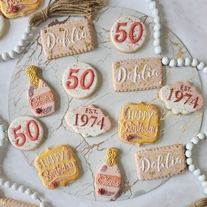 A dozen handmade sugar cookies ready to give as a 50th birthday gift. Choose the name, message, color and design you want for your party.
