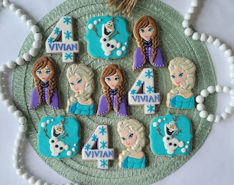 These 12 delicious cookies are decorated with designs inspired by Frozen's characters, including Olaf, Elsa, Ana, and a birthday number