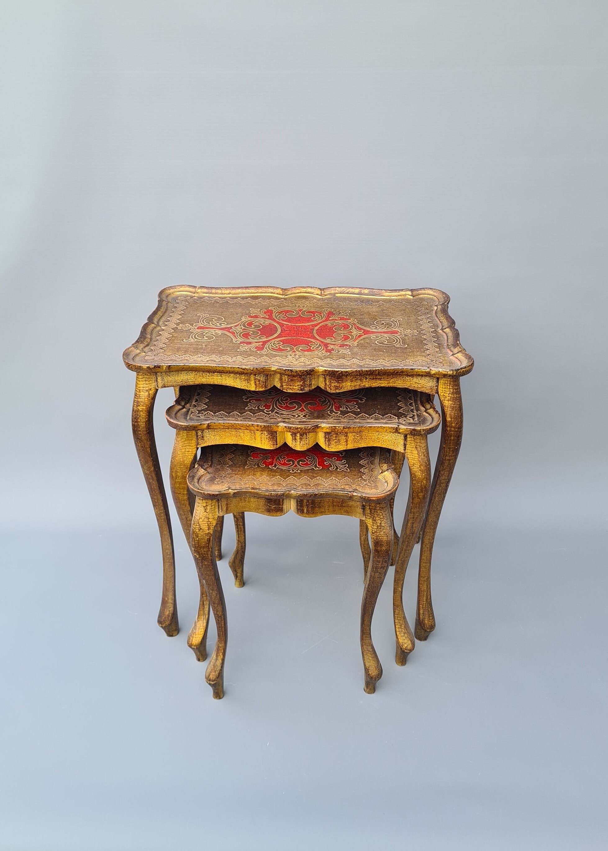 Set of three wood nesting tables in Florentine style, gold