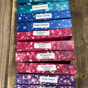 May include: A collection of ten resin blanks in various colors and patterns, including Caribbean Morning, Deep Ocean, Strawberry Sparkle, Pomegranate Surprise, and Purple Twilight.