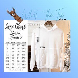 May include: A plain white hooded sweatshirt displayed on a hanger, accompanied by a size chart titled What The Tee Shop. The chart lists unisex hoodie measurements in inches for sizes S through 5XL, including width, length, and sleeve length.