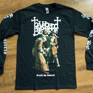 May include: Black long-sleeved shirt with a historical illustration of three figures. The shirt has white text on the sleeves and front, including the words "Reverend Bizarre" and "Crush the Insects."