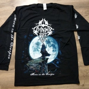 May include: Black long-sleeve t-shirt with a white print of a band logo and the words "Moon in the Scorpio".