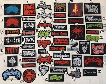 May include: A collection of embroidered patches with various band logos and text, including "Fudge Tunnel", "Cancer", and "Melvins". The patches are in various colors and designs, on a black background.