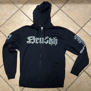May include: Black zip-up hoodie with a white and grey "Druish" logo on the front and a grey "Druish" logo on the left sleeve.