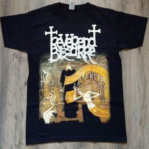 May include: Black t-shirt with a white graphic print of the band "Reverend Bizarre". The graphic features a cross and a dark figure in a long robe.