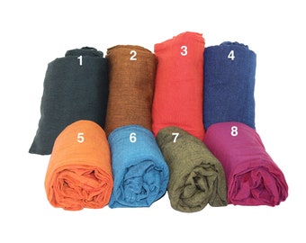 May include: Eight rolled fabric swatches in various colors, including dark green, brown, red, blue, orange, teal, olive green, and magenta. The swatches are numbered 1 through 8.