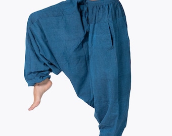 May include: A pair of blue, loose-fitting pants with a drawstring waist. The pants are made of a soft, comfortable fabric and have a relaxed fit.