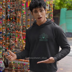 May include: A black hoodie with a green lotus flower and the text "ISKCON" printed on the front.