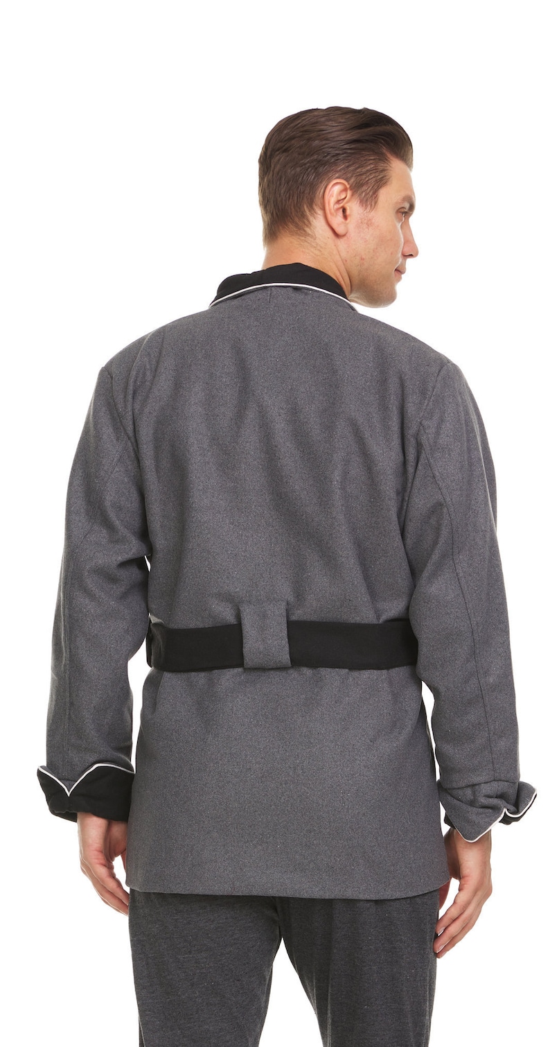 May include: A gray long-sleeved jacket with a black belt and white piping around the collar and cuffs.