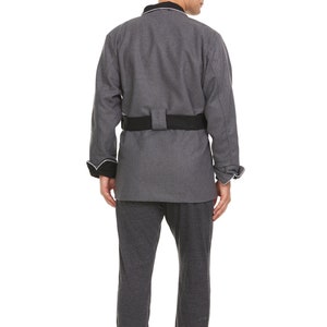 May include: A gray robe with a black belt and white piping around the collar and cuffs. The robe is made of a soft, comfortable fabric and has a relaxed fit.