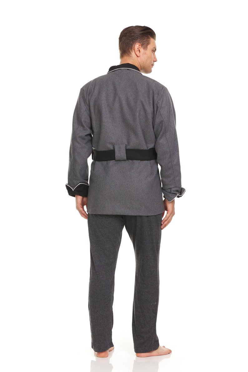 May include: A gray robe with a black belt and white piping around the collar and cuffs. The robe is made of a soft, comfortable fabric and has a relaxed fit.
