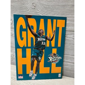 May include: A teal and orange basketball poster featuring Grant Hill in a teal Detroit Pistons jersey with the number 33. The poster has the word "GRANT HILL" in large orange letters.