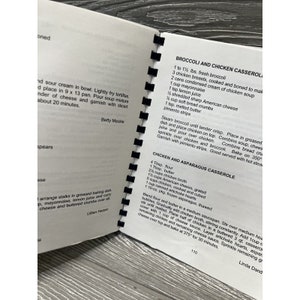 May include: A close-up of a cookbook page with two recipes: Broccoli and Chicken Casserole and Chicken and Asparagus Casserole. The recipes include ingredients and instructions for preparing the dishes.