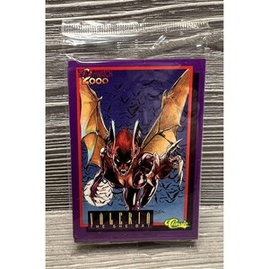 May include: A purple trading card featuring a comic book character called "Valerio The She-Bat" from the "Witchwatch 2000" series. The card has a classic logo in the bottom right corner.