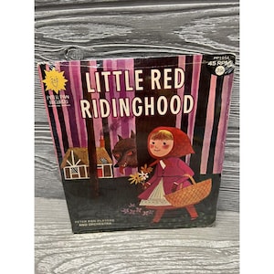 May include: A vintage record album cover featuring a red-hooded girl walking through a forest with a wolf and a basket. The title of the album is "Little Red Ridinghood" and the record label is "Peter Pan Records".