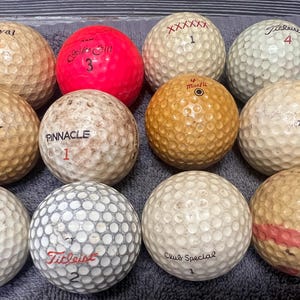 One Dozen Assorted Vintage Golf Balls