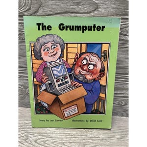 May include: A children's book titled "The Grumputer" with illustrations of an elderly couple and a retro computer. The cover is green with the title in bold black letters. The book is in a cardboard box.