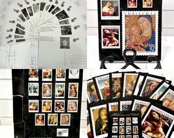 May include: A collection of vintage Christmas stamp image postcards featuring religious art. The postcards showcase classic paintings of Madonna and Child, with various stamps and a black display stand. The stamps are from the National Gallery of Art.