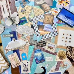 May include: A collage of various beach-themed elements, including framed photos, seashells, and decorative paper cutouts. The color palette includes blues, whites, and tans. There is a jar with a coral reef design and the text "Smile".