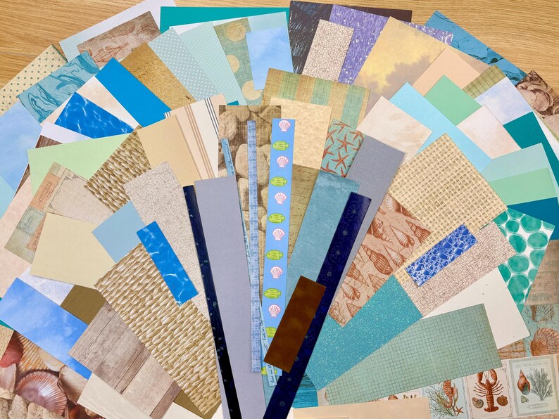 May include: A collection of assorted paper sheets in various sizes and patterns. The papers feature a coastal theme with seashells, starfish, and ocean wave designs in shades of blue, beige, and brown. Ideal for scrapbooking and crafting.