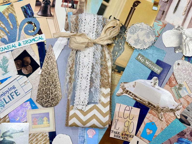 May include: A collage of coastal-themed craft supplies. It includes lace ribbons, tags with text like "Coastal & Tropical" and "Enjoying Life", and decorative elements in shades of blue, beige, and gold. The words "Let it go" are also visible.