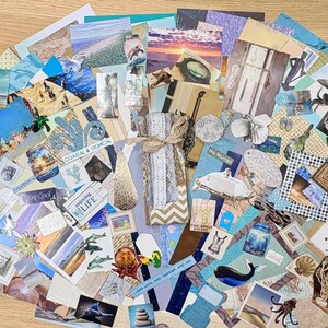 May include: A collection of assorted paper ephemera with a coastal and tropical theme. The collage includes images of beaches, seashells, and marine life, with various shades of blue, beige, and white. Some pieces have text, and the arrangement is fanned out.
