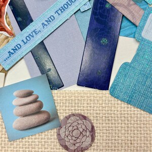 May include: A collage featuring various paper elements in shades of blue, gray, and beige. Includes a square image of stacked stones, a floral design, and a strip of paper with the text "...AND LOVE, AND THOUGHT".