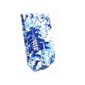 May include: A blue and white patterned clutch purse with a flap closure. The pattern features a pagoda and trees.