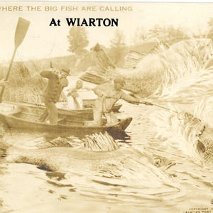 May include: A vintage postcard featuring a black and white photo of a group of people fishing in a boat. The caption reads "Come where the big fish are calling at Wiarton".