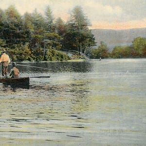 May include: Two people in a wooden rowboat on a lake, fishing with a long fishing rod. The lake is surrounded by trees and the sky is cloudy.