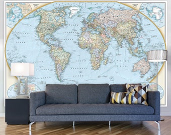 May include: A blue couch with two pillows sits in front of a large world map mural. The map is a light blue color with brown and green continents. The couch is in a living room setting with a lamp on a side table.