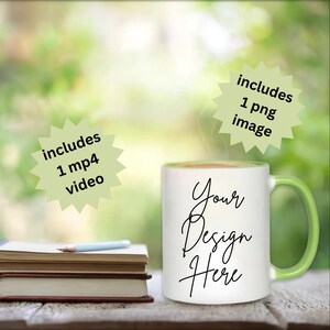 May include: White ceramic mug with a green handle and rim, featuring the text "Your Design Here" in black script. The image includes text that says "includes 1 mp4 video" and "includes 1 png image". A stack of books and a pencil are in the background.