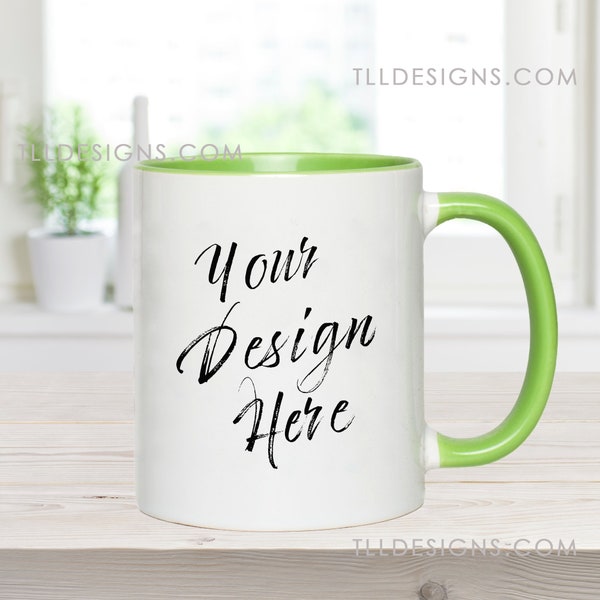 11 oz white mug with green accent handle mockup in a clean, modern kitchen with plants background