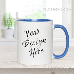 11 oz white mug with blue accent handle mockup in a clean, modern kitchen with plants background