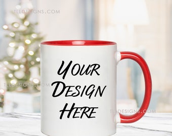 May include: White ceramic mug with a red rim and handle. The mug has the text "YOUR DESIGN HERE" printed in black.