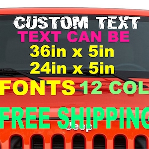 May include: A red Jeep with a custom text decal on the windshield. The decal is white with black outlines and says "CUSTOM TEXT TEXT CAN BE 36in x 5in 24in x 5in 54 FONTS 12 COLORS FREE SHIPPING".