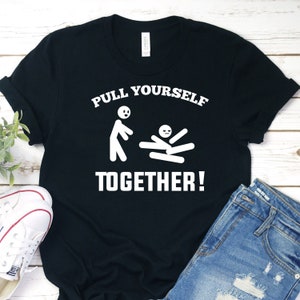 May include: Black t-shirt with white text that reads "Pull Yourself Together!" and a stick figure graphic.