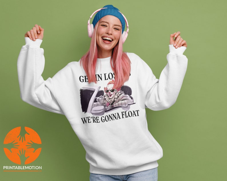 May include: White sweatshirt with a graphic of a clown driving a car. The text on the sweatshirt says "Get in Loser, We're Gonna Float."